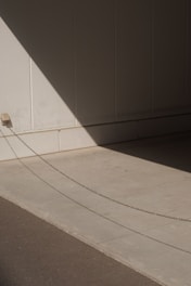 white concrete staircase near gray wall