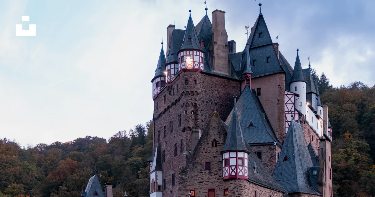 A large castle with a lot of towers on top of it photo – Free Free ...