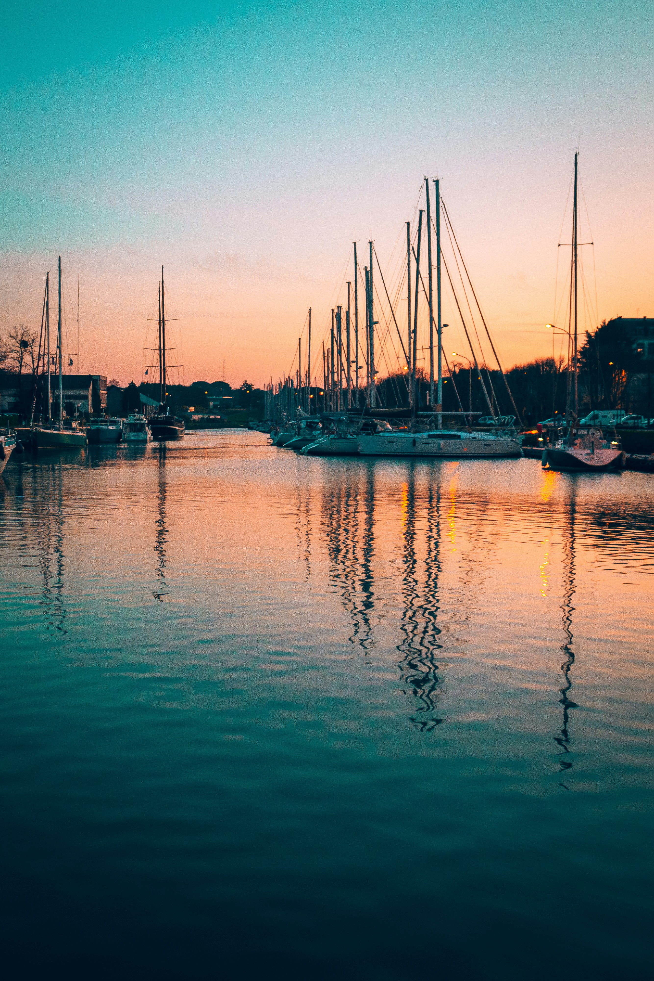 silhouette of boat on sea during sunset