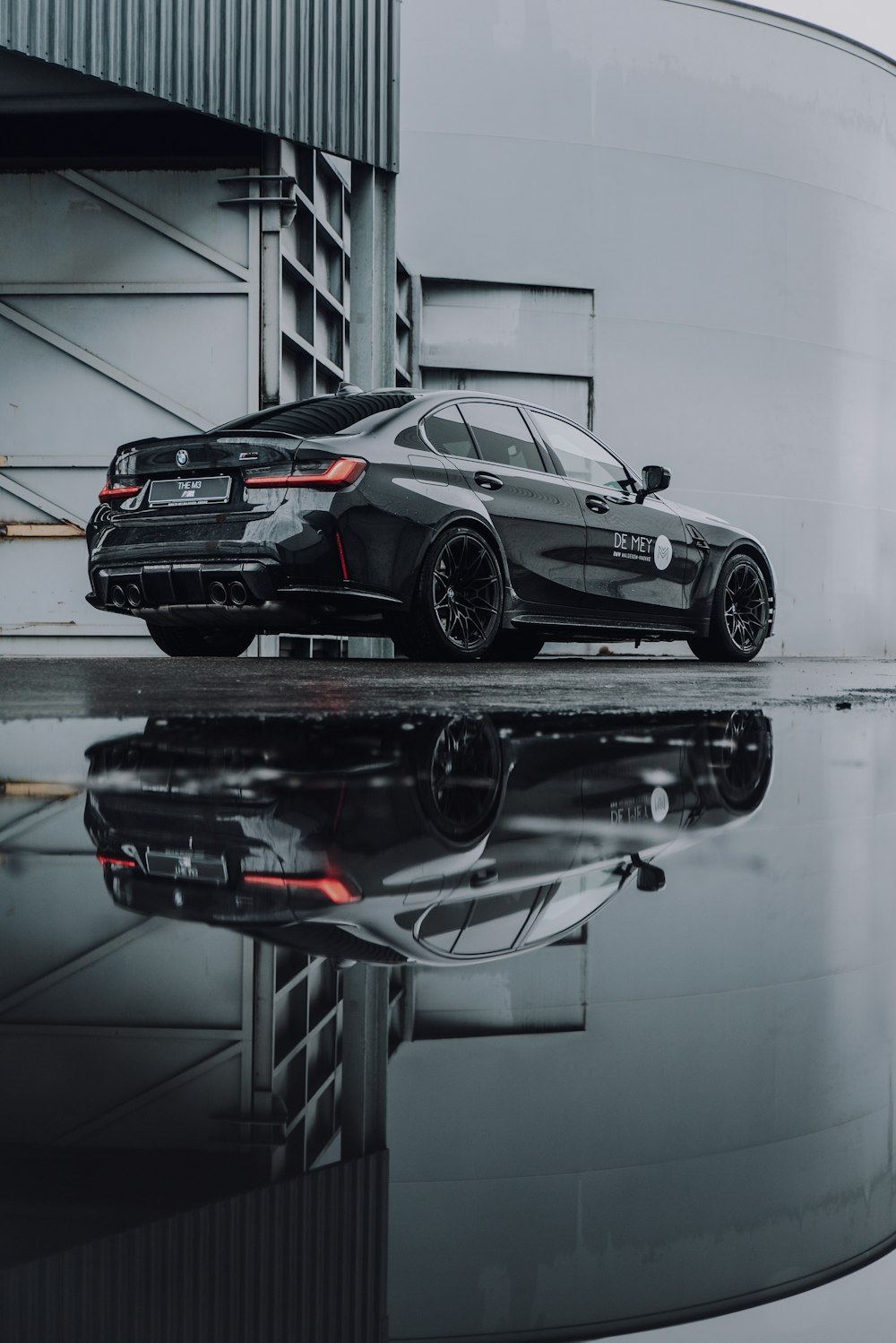 black coupe on a garage