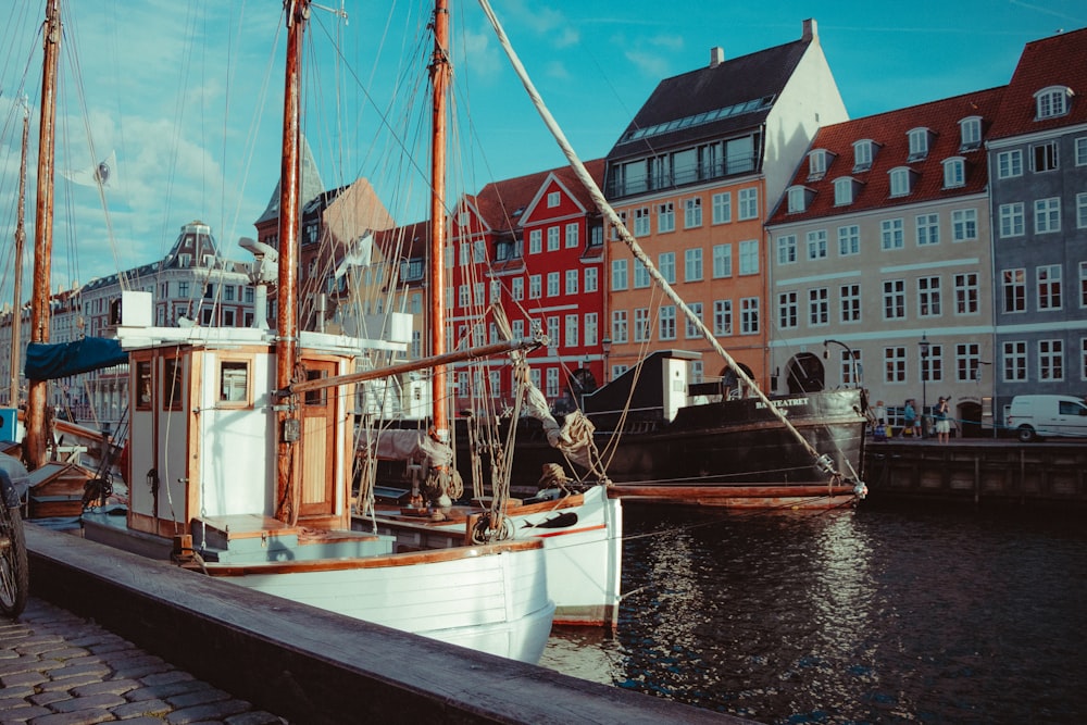 white and brown boat on dock during daytime