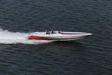 white and red boat on water during daytime