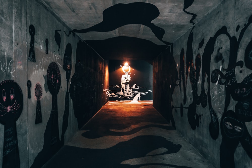 person in black jacket standing on tunnel