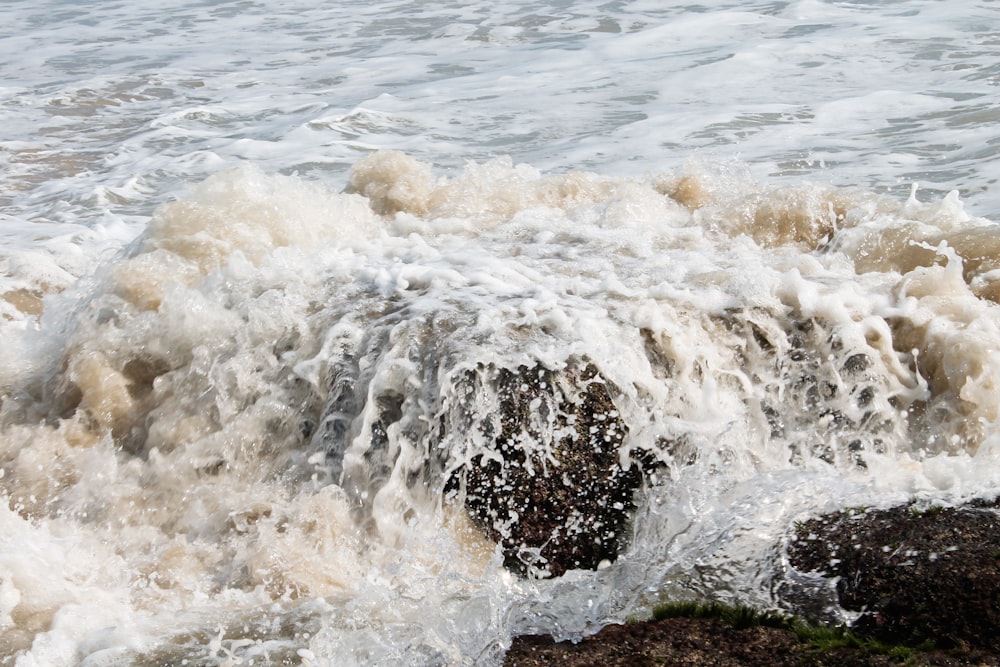 ocean waves crashing on shore during daytime