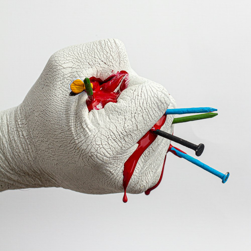 white and red rose on white textile