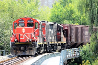 red and black train on rail tracks during daytime