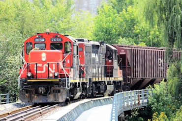 red and black train on rail tracks during daytime