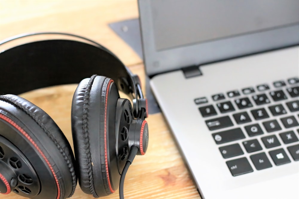 black and gray headphones on macbook pro