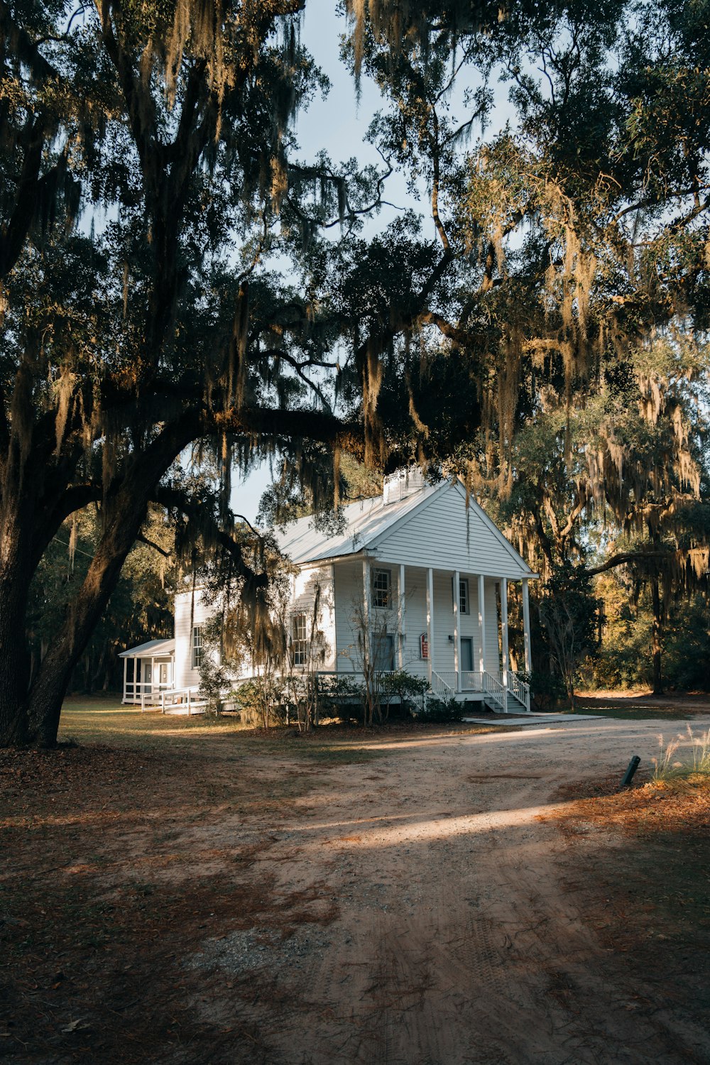 white wooden house near trees during daytime