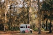 A cozy compact travel trailer nestled in a forest clearing