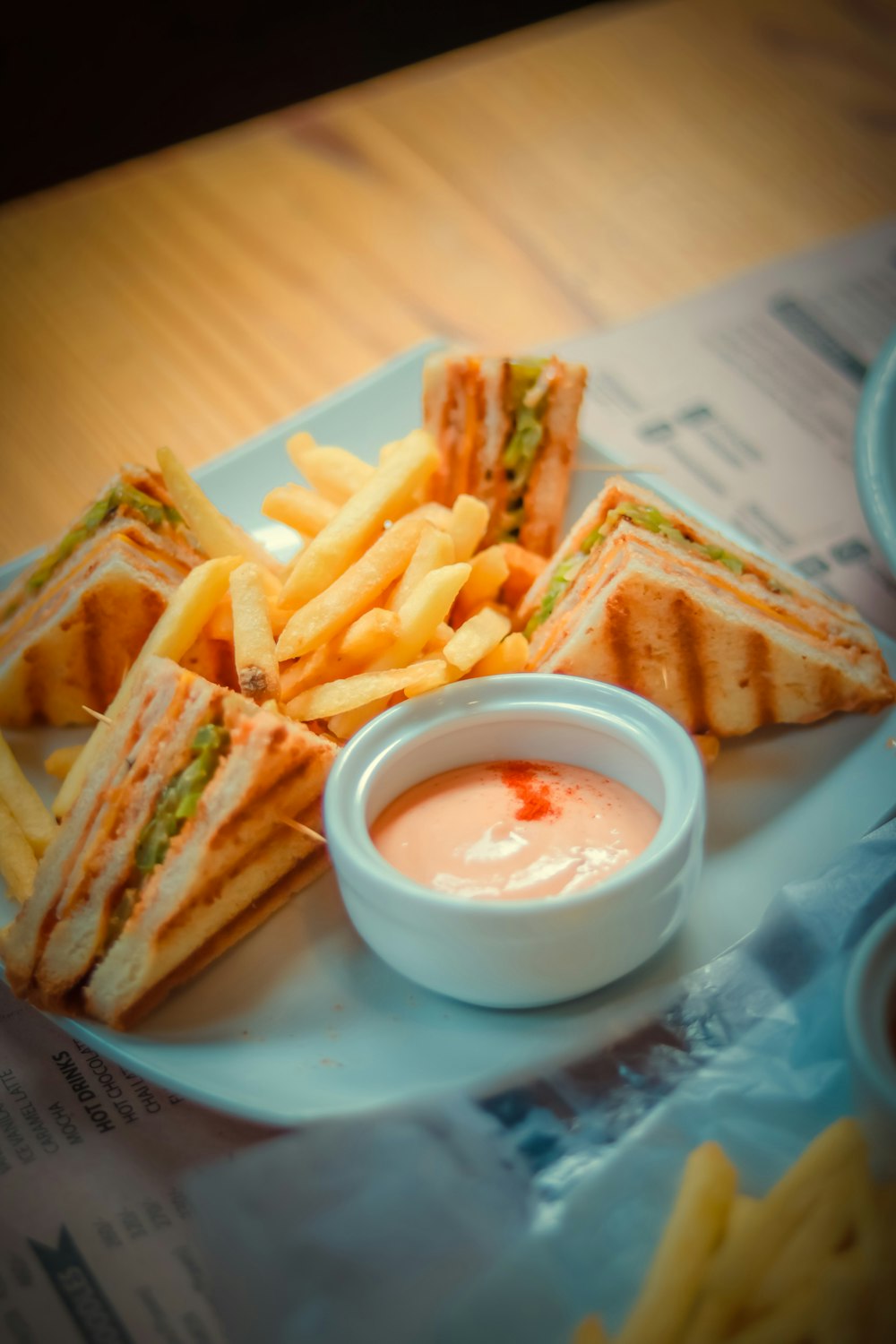 fries on white ceramic bowl beside white ceramic bowl with sauce