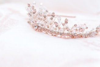 silver diamond studded accessory on white surface