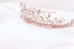 silver diamond studded accessory on white surface