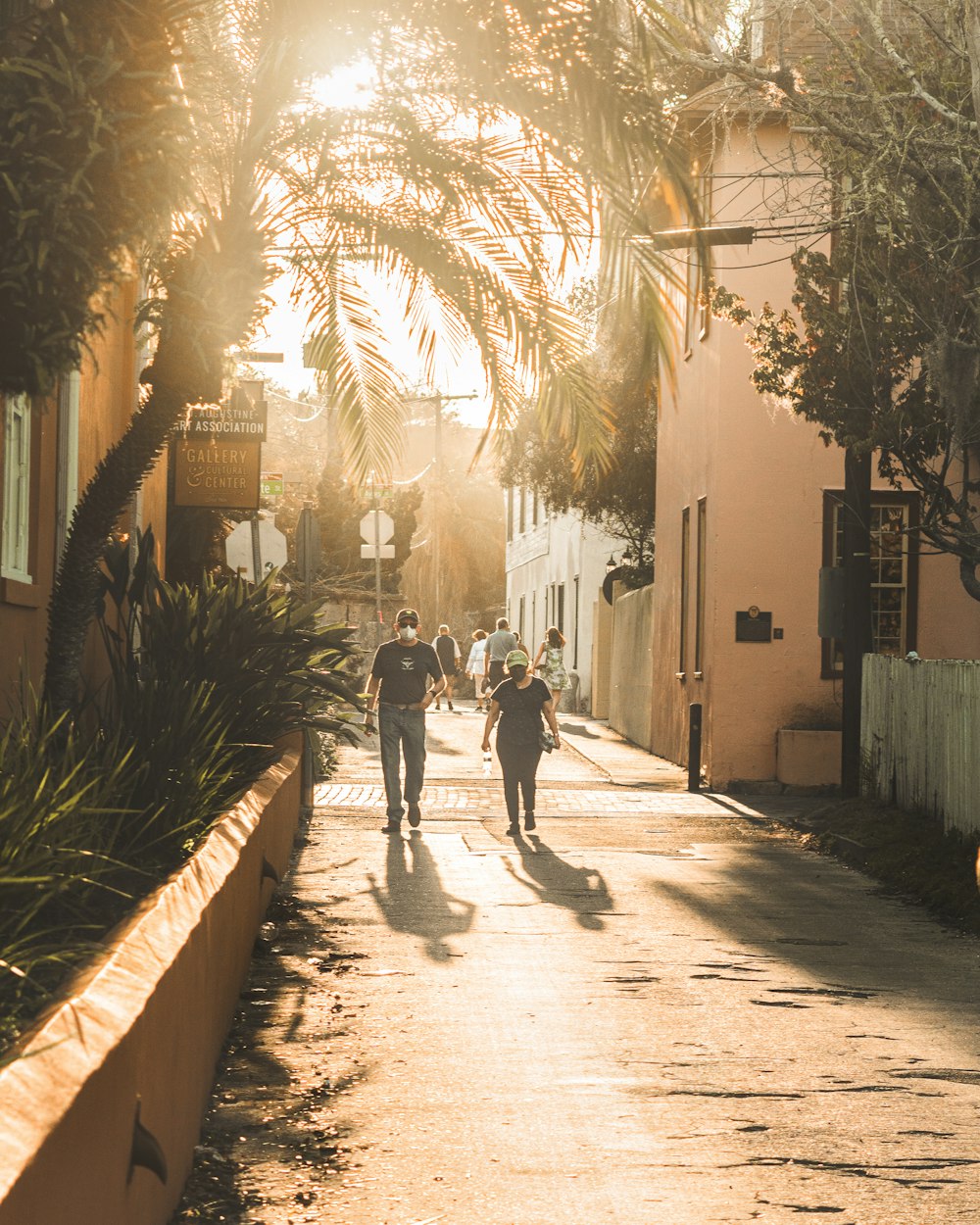 man and woman walking on sidewalk during daytime