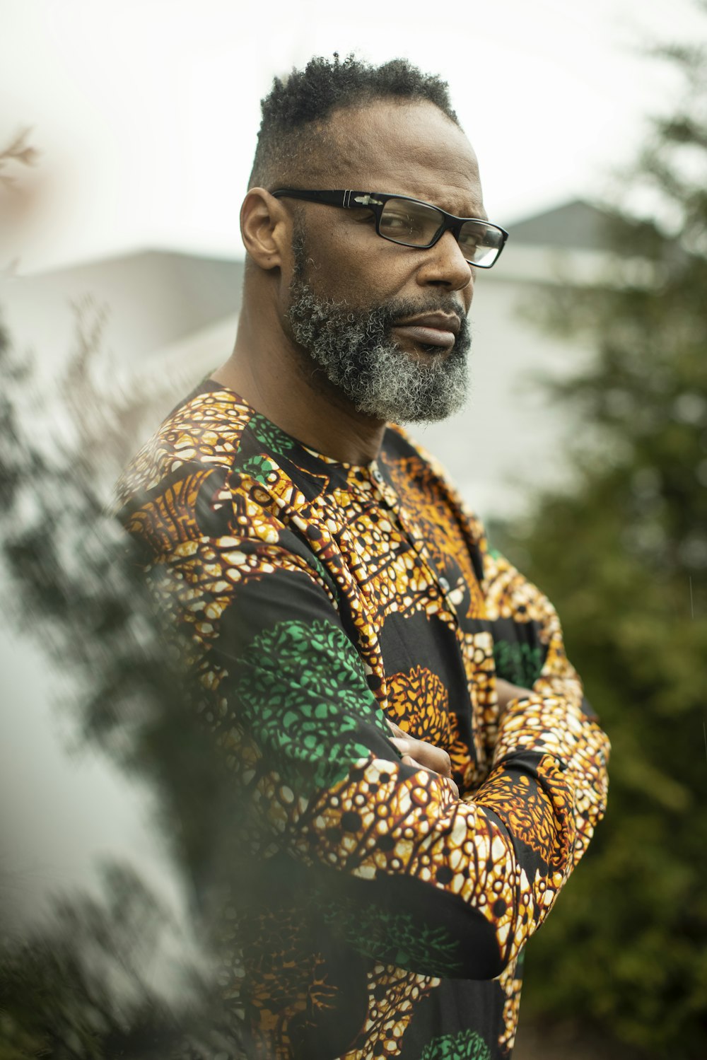 man in brown and green floral scarf and black sunglasses