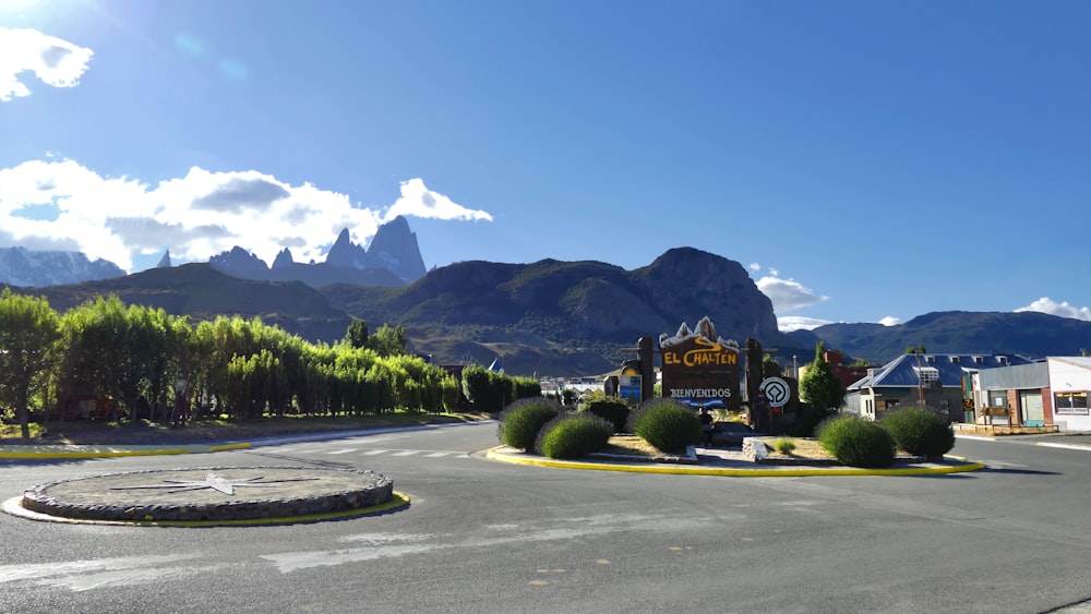 green trees near mountain under blue sky during daytime