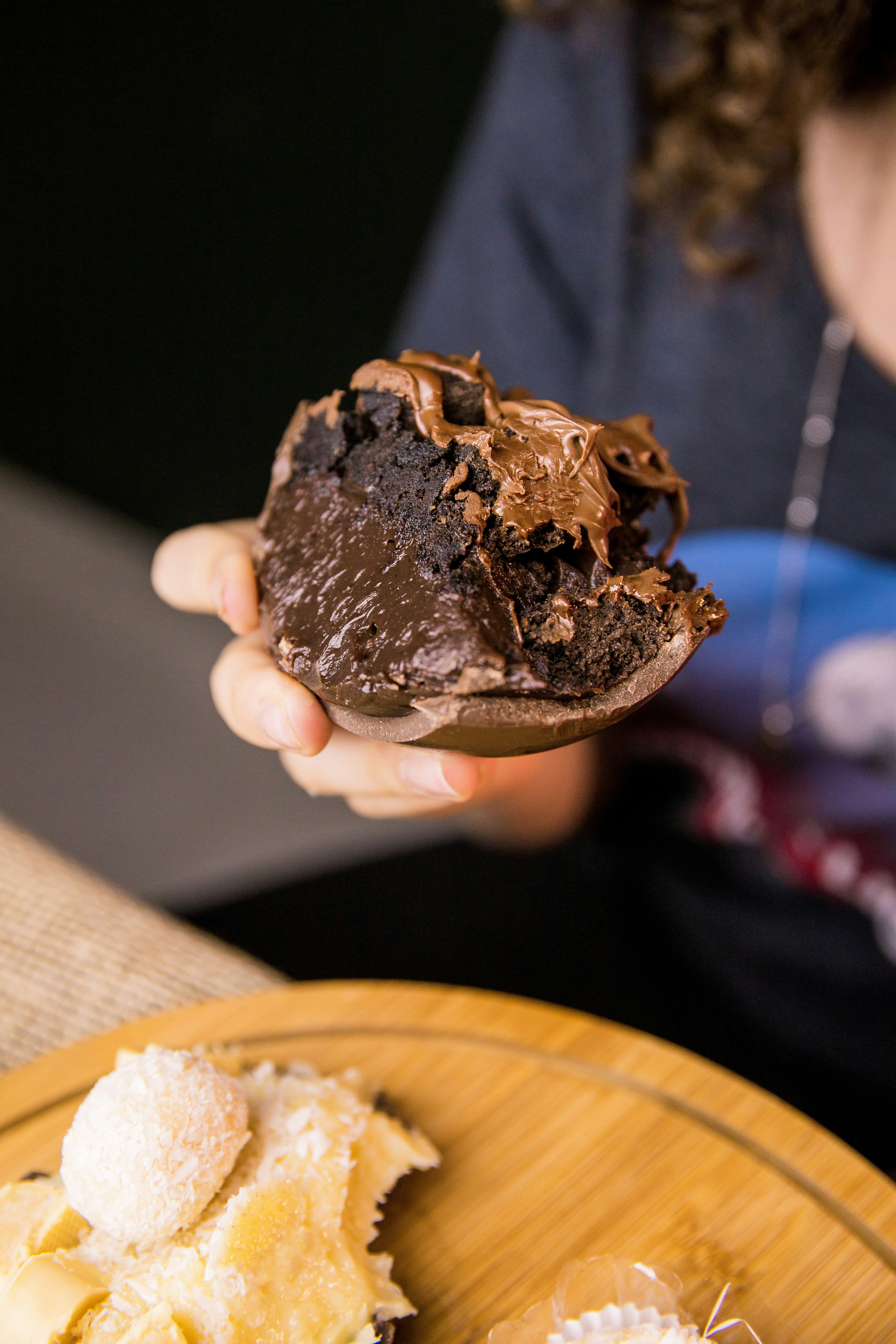 person holding chocolate ice cream