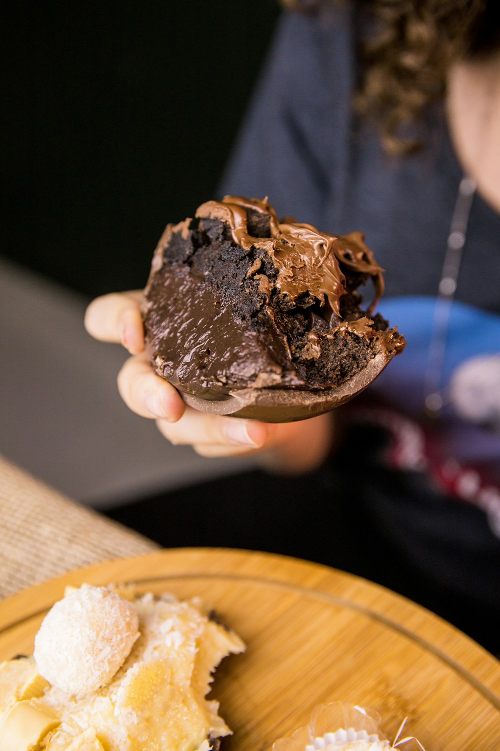 person holding chocolate ice cream