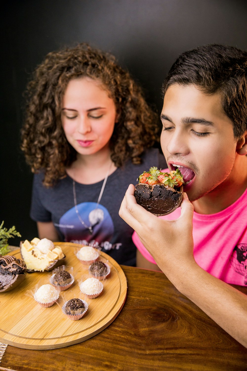 girl in pink shirt eating chocolate cake