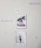 A wall with five pieces of art decor including a sign that says 'Be fearless', a picture of a pink van by palm trees, a sign that says 'Regret Nothing', a picture of an open book with flowers, and a small sign that says 'family forever'. The wall appears to have some tape or marks.