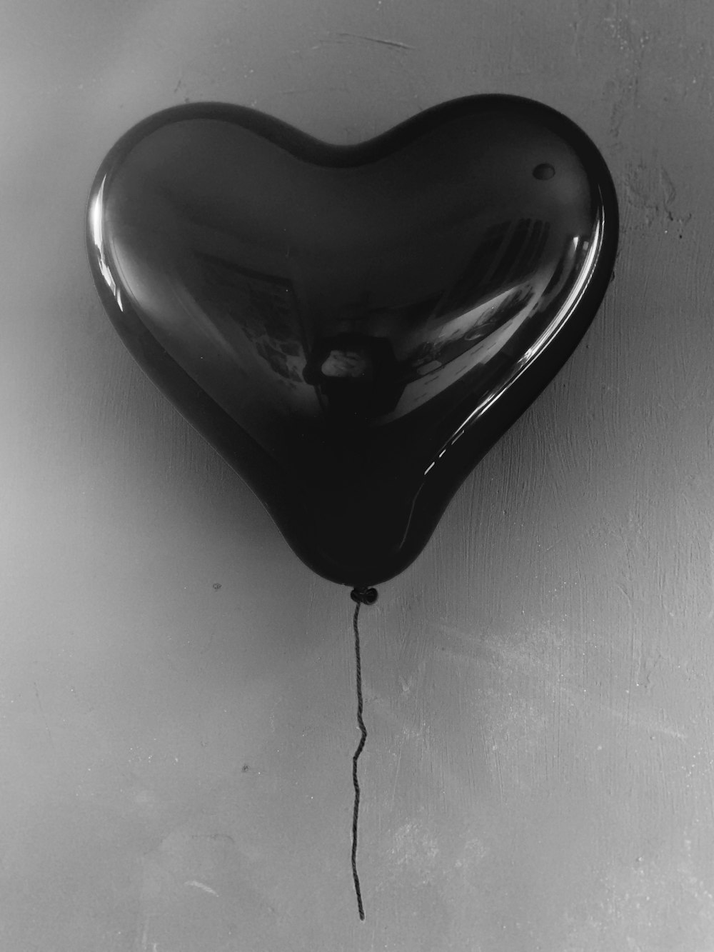 black heart shaped pendant on white surface