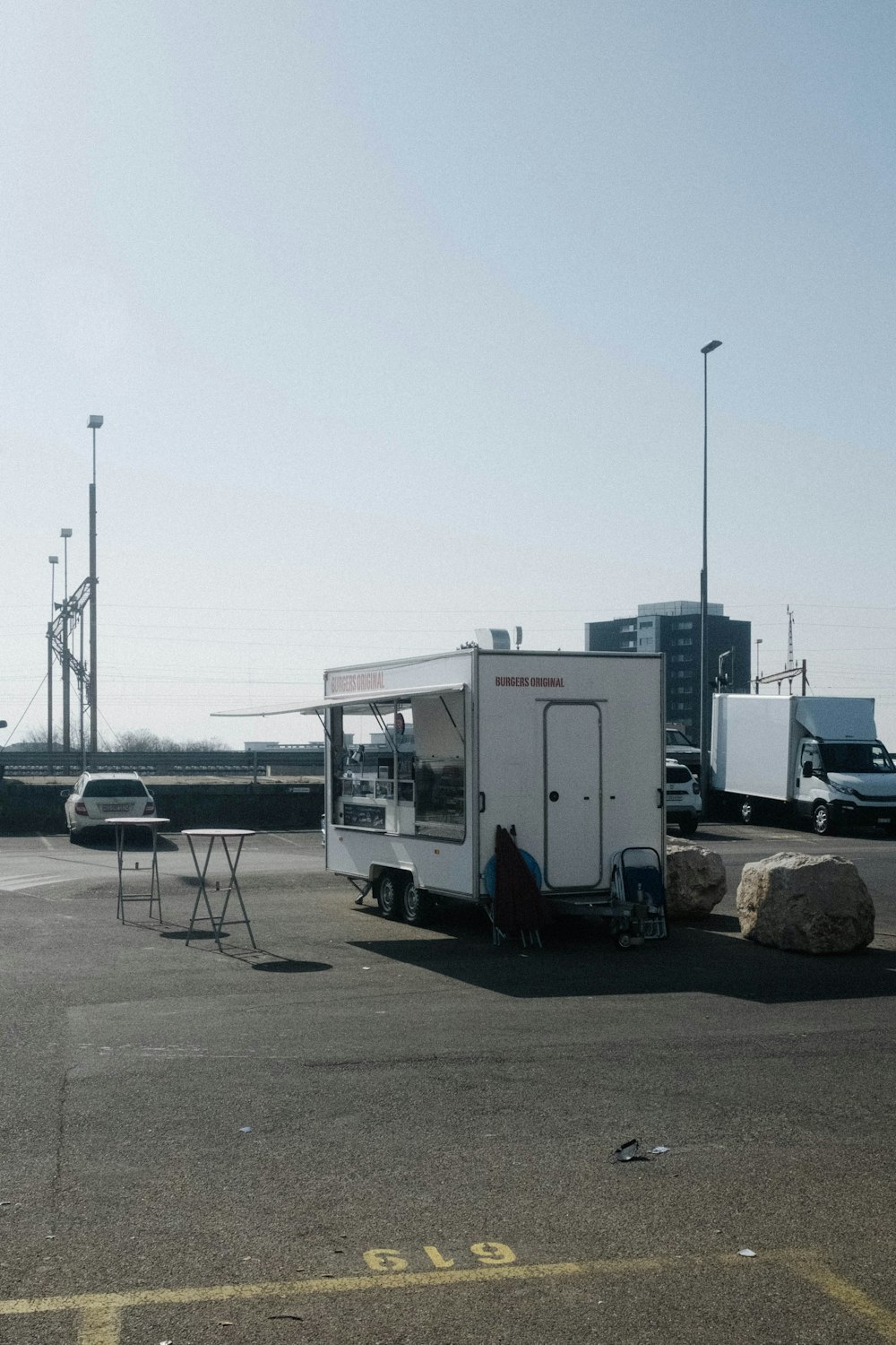 white and black trailer truck on gray concrete road during daytime