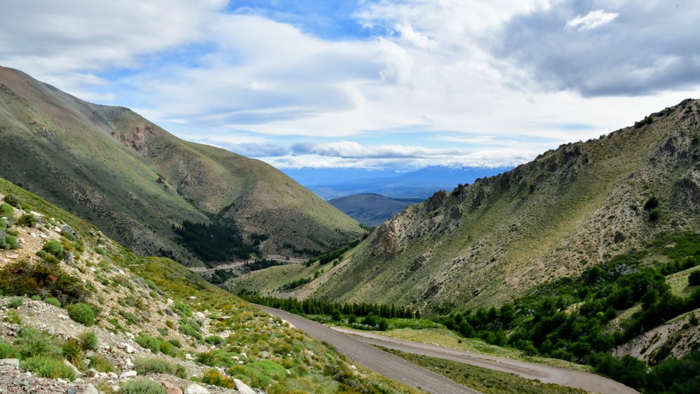 green mountains under white clouds during daytime