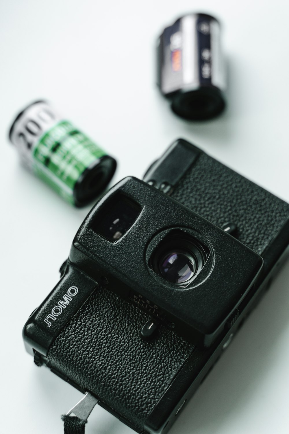 black and silver camera on white table