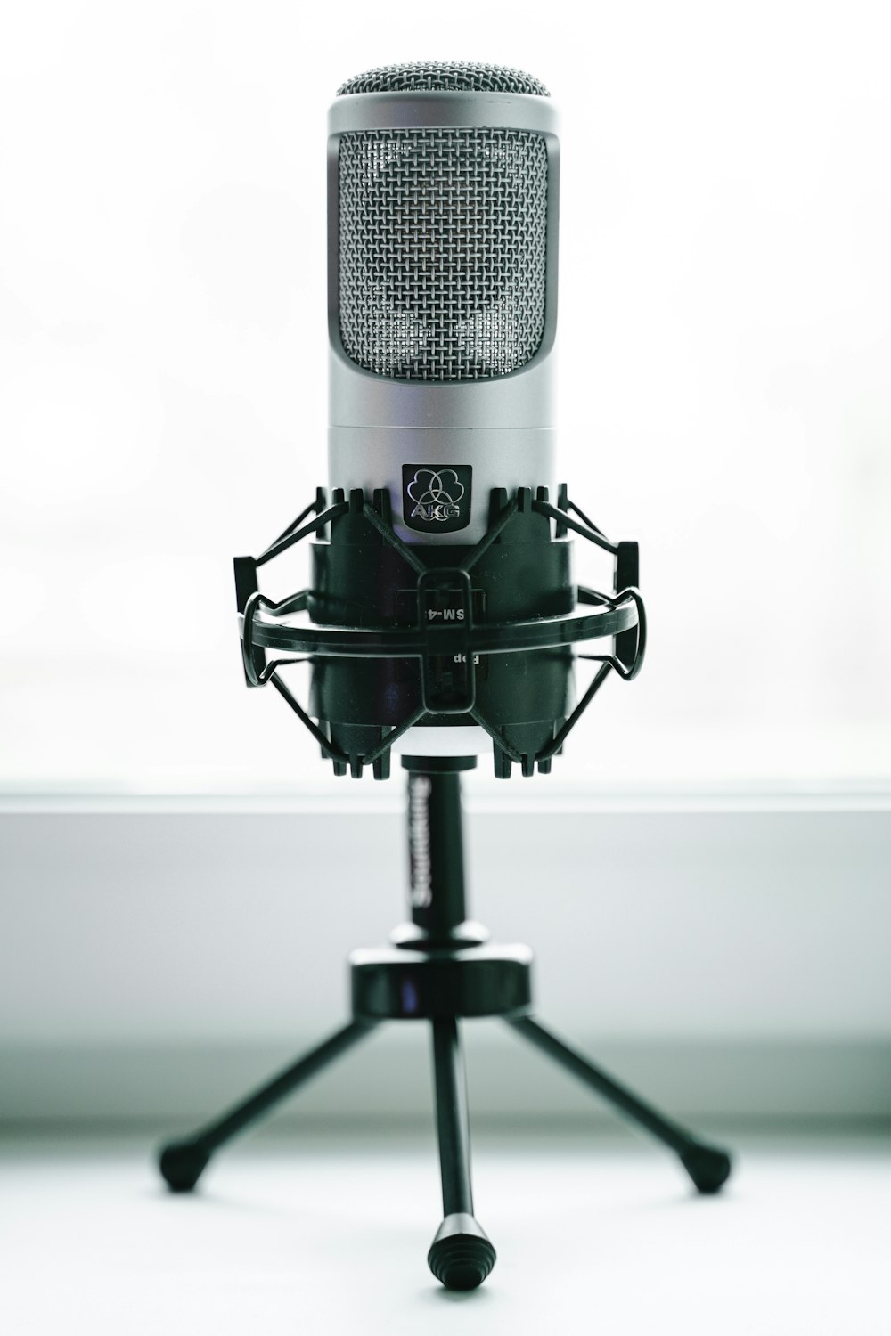 black and gray microphone with stand