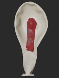 white heart shaped balloon with red paint