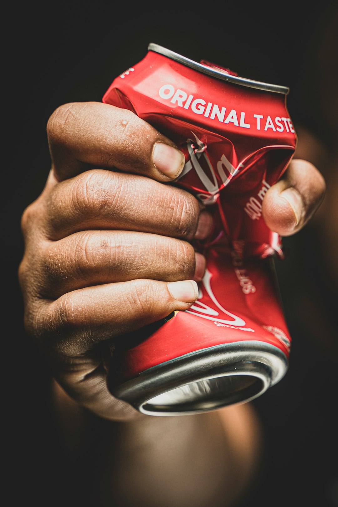coca cola cherry can on persons hand