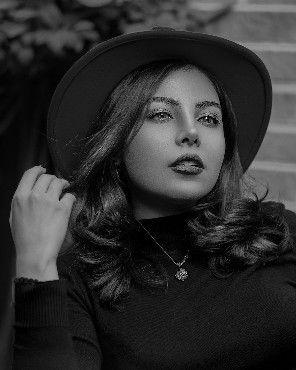 woman in black long sleeve shirt wearing black hat