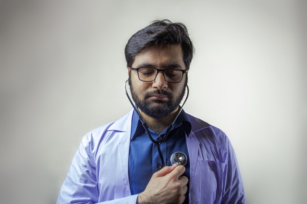 man in white dress shirt wearing blue and black headset