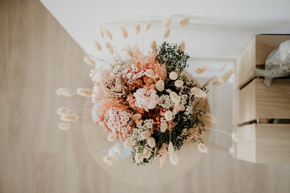 pink and white flowers on white textile