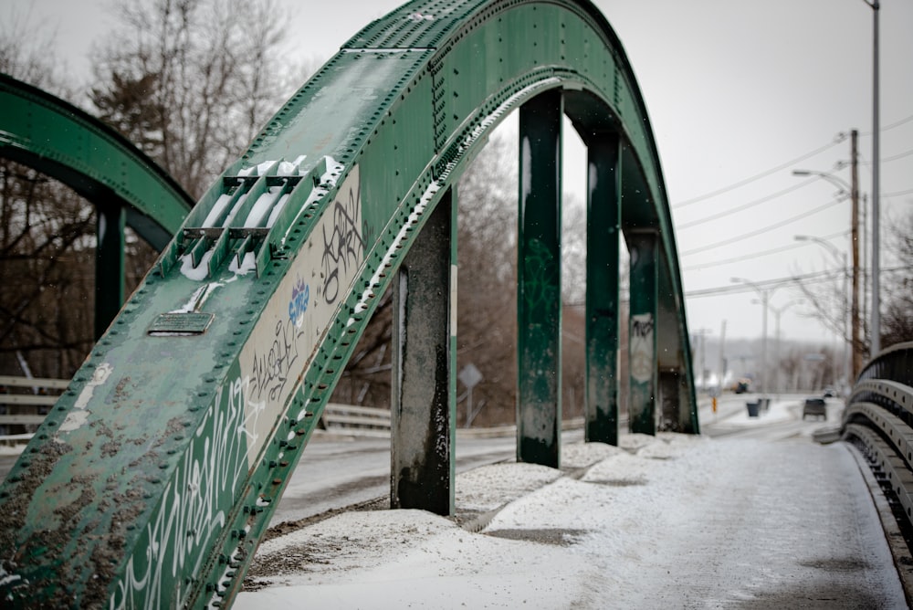 green wooden bridge over river