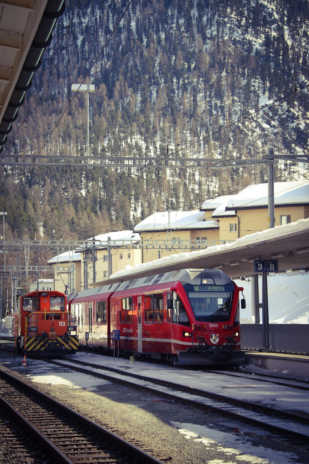 red and white train on rail tracks