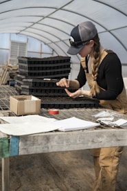 woman in black long sleeve shirt holding black pen