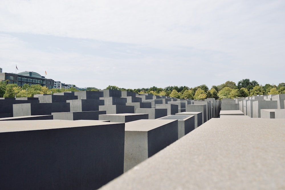 gray concrete blocks near green trees during daytime