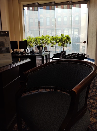 A friendly cooperative advisor helping a client review loan options in a bright office.