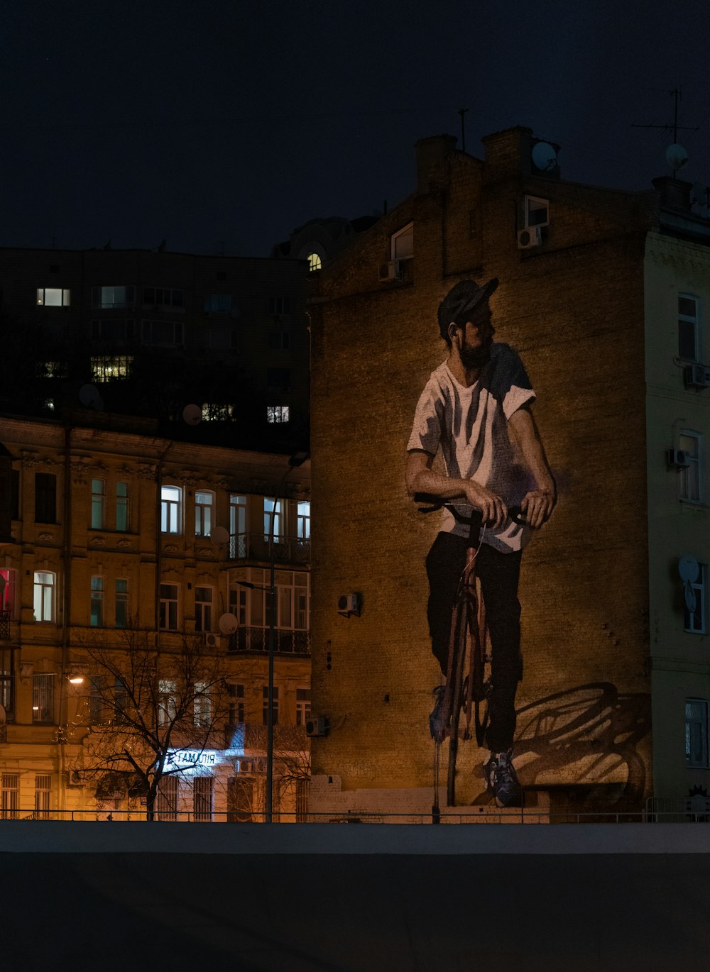 man in brown long sleeve shirt standing near building during night time