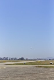 Student pilot taking off in a small training aircraft on a sunny runway.