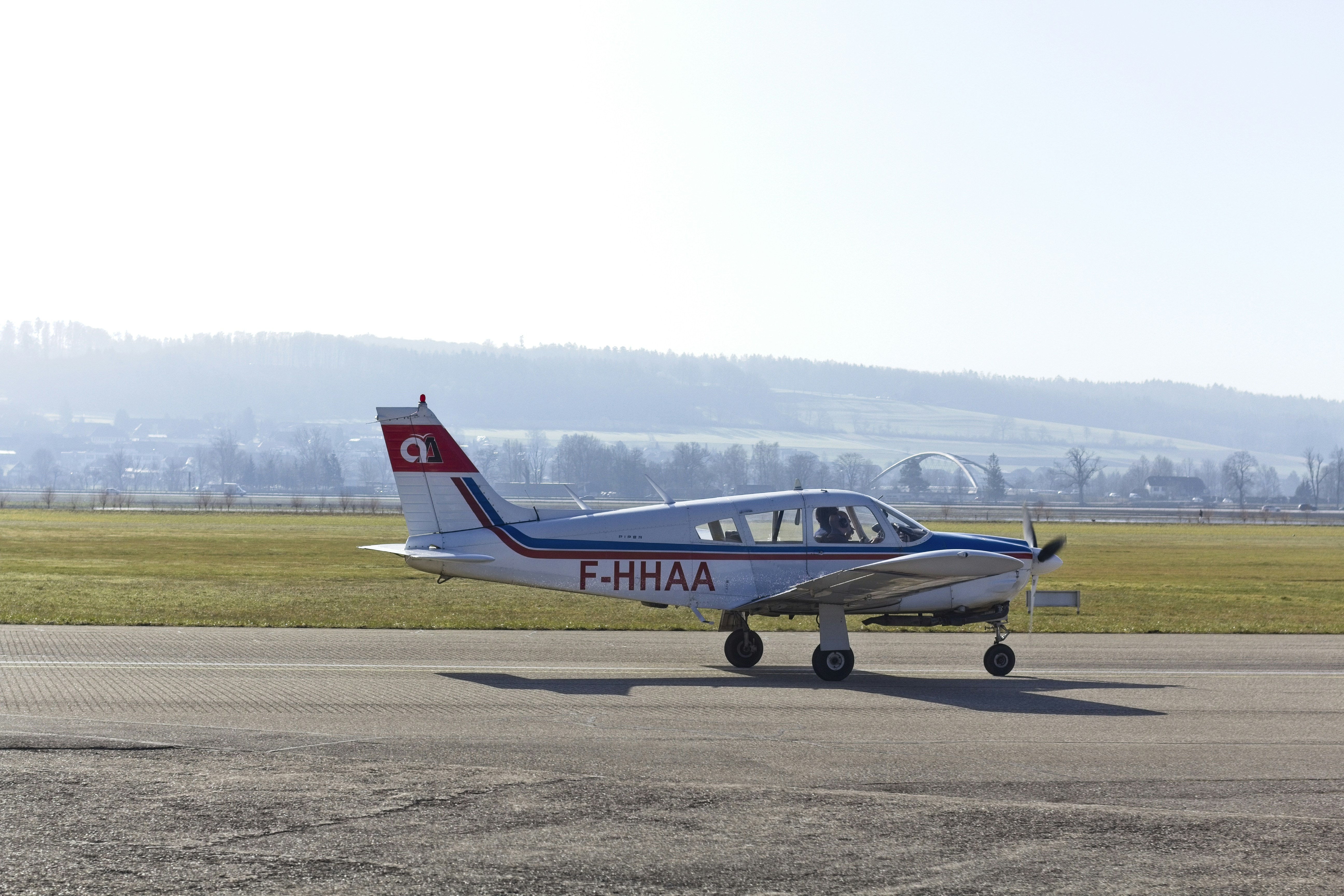 red and white airplane on gray concrete ground during daytime
