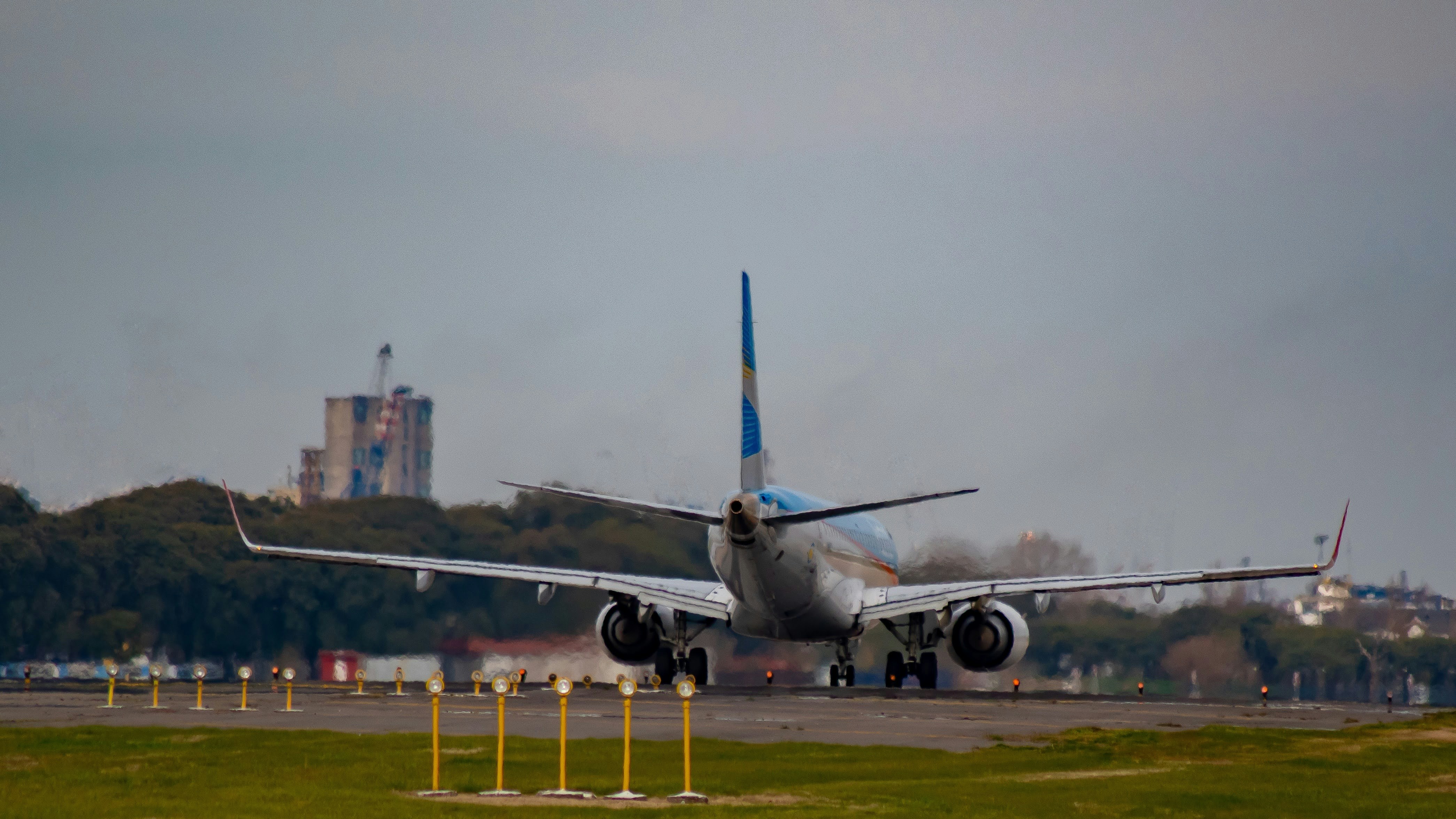 white and blue airplane on green grass field during daytime, 