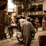 Group of Indian Navy veterans exploring a vibrant Chinese market street.