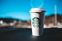 white and green starbucks disposable cup