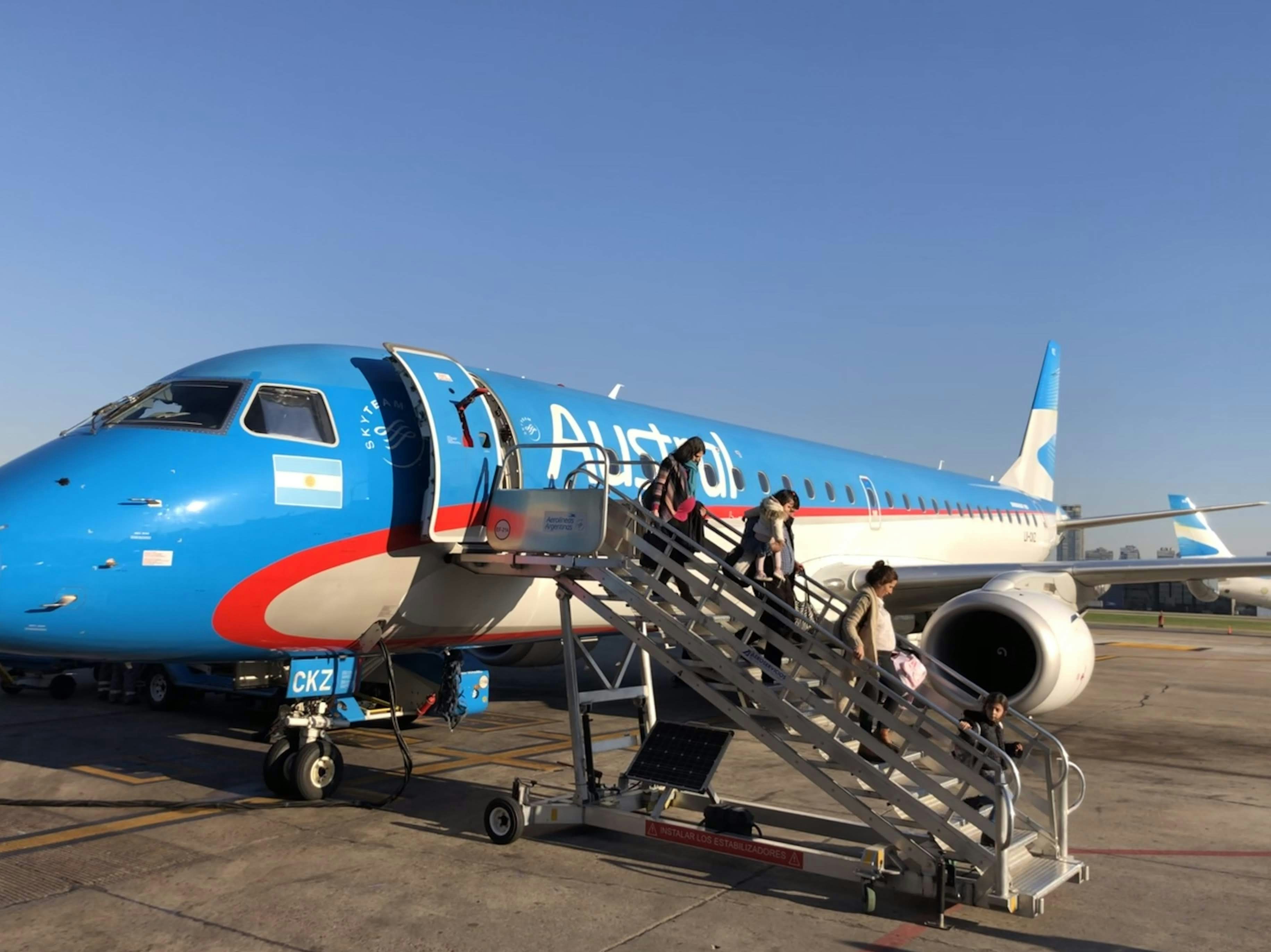 blue and white airplane under blue sky during daytime