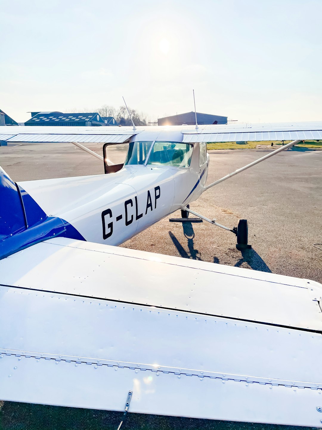 white and blue airplane on brown sand during daytime