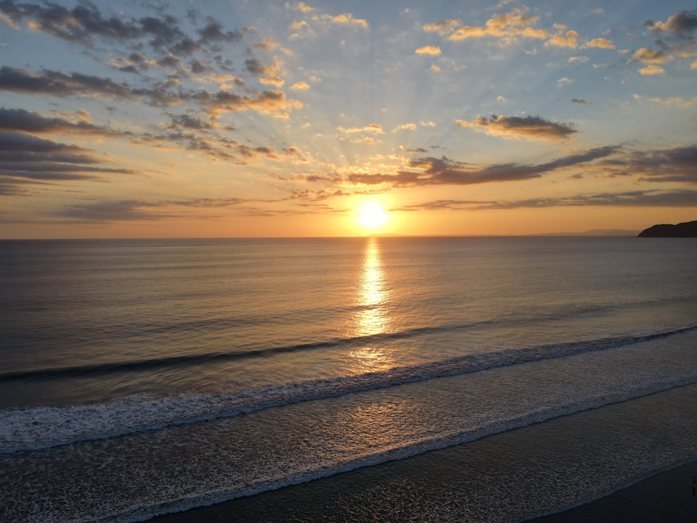 body of water during sunset