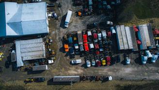 A sleek yard truck being driven inside a busy warehouse yard.