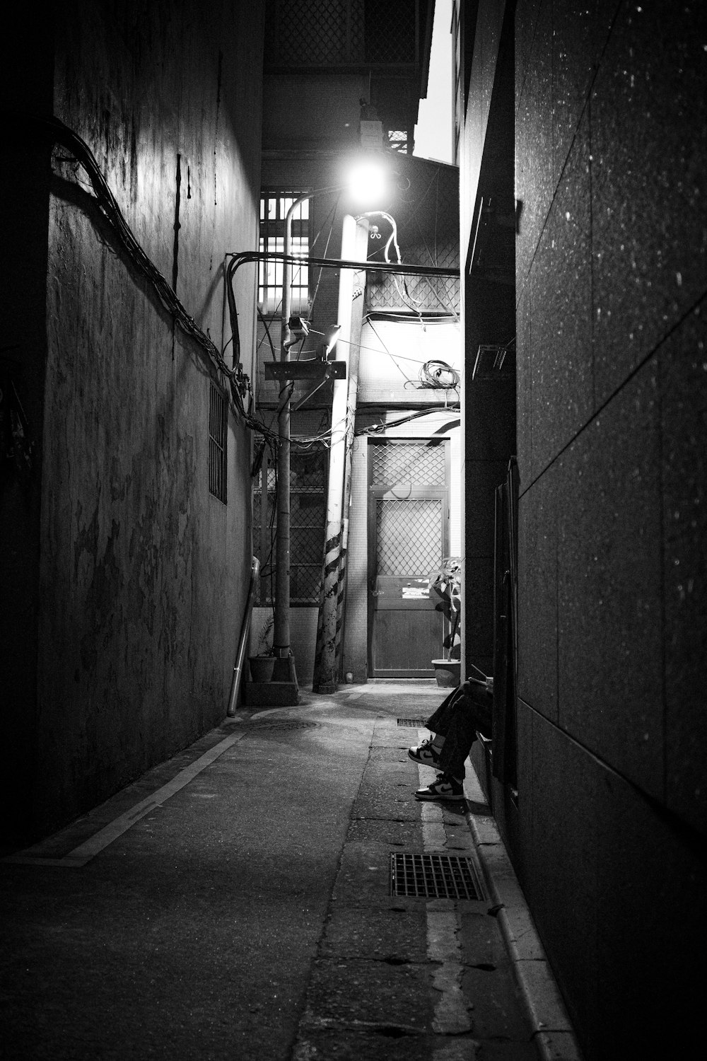 man in black jacket walking on hallway